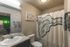 Chic bathroom with elegant shower curtain, modern sink, and stylish mustache wall art.