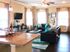 Inviting open-concept living room with modern decor, cozy couches, and ample natural light, perfect for relaxation.