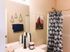 Inviting bathroom with stylish geometric wall decor, vibrant artwork, and a modern blue-patterned shower curtain. Elegant countertop accessories add a touch of luxury.