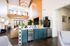 Bright and modern open-concept living space with loft-style design, showcasing elegant lighting and a stylish kitchen area.