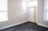 Bright entryway featuring sleek dark wood flooring and ample natural light through large windows.