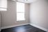 Bright and airy corner of a room with sleek flooring and large windows, perfect for a personalized touch in your new home.