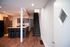 Inviting open-concept living space featuring a modern kitchen with granite countertops and a sleek staircase, perfect for contemporary living.