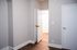 Bright and inviting interior featuring modern white doors, elegant wooden flooring, and crisp gray walls, offering a clean canvas for personalized d&eacute;cor.