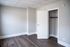 Bright and inviting room featuring sleek hardwood flooring, a spacious closet, and a modern white door.
