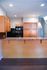 Sleek kitchen space with stylish wooden cabinets, modern appliances, and a chic countertop, perfect for culinary enthusiasts.