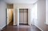 Bright and inviting bedroom featuring freshly painted walls, rich hardwood floors, and a spacious open closet, perfect for modern living.