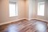 Bright and inviting room featuring elegant hardwood flooring and large windows, perfect for a cozy bedroom or modern office space.