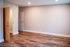 Inviting apartment interior showcasing elegant wood flooring and soft ambient lighting.