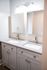 Modern bathroom featuring a sleek dual-sink vanity with elegant fixtures and bright lighting.