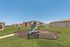 Charming apartment complex with a vibrant playground and lush green lawns, ideal for family living.
