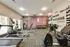 Modern fitness center featuring state-of-the-art exercise equipment, motivational wall art, and large windows for natural light.
