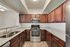 Modern kitchen with rich wooden cabinetry, sleek stainless steel appliances, and elegant granite countertops.