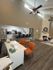 Inviting modern apartment with open-concept kitchen, cozy living area, and elegant high ceilings.