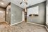 Bright, modern room with elegant wood flooring, stylish ceiling fan, and abundant natural light through large windows.