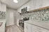 Modern kitchen with sleek stainless steel appliances, bright granite countertops, and stunning mosaic backsplash.