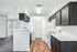 Contemporary kitchen with sleek dark cabinets, modern appliances, and inviting open layout, perfect for entertaining.