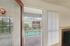 Inviting apartment balcony with pool view and modern exterior, offering a private and tranquil living space.