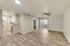 Modern open-concept living space with elegant wood flooring, sleek kitchen design, and abundant natural light.