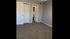 Inviting bedroom with plush carpeting, soft gray walls, and classic white doors, enhanced by elegant ceiling lighting.