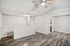 Modern apartment interior with bright, spacious living area featuring stylish wooden flooring and sleek ceiling fan.