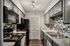 Modern kitchen with sleek gray cabinets, stylish black appliances, and chic tile backsplash for a contemporary look.