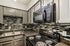 Modern kitchen featuring sleek granite countertops, stylish tile backsplash, and contemporary appliances.