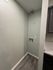 Charming laundry nook with sleek vinyl flooring and modern cabinetry, perfect for utility and style.