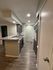 Modern kitchen with sleek gray cabinetry, textured walls, and elegant gray countertops, enhancing the stylish ambiance.