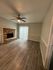 Inviting living room with soft sea salt colored walls, and a modern ceiling fan, perfect for relaxation.