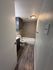 Inviting bathroom with a nice sea salt color walls, and classic white doors, enhanced by elegant shower panels