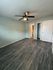Inviting bedroom with soft sea salt colored walls, and a modern ceiling fan, perfect for relaxation.