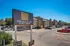 Inviting exterior view of Spring Hollow Apartments with ample parking and a welcoming entrance sign, located at 2703 N. Buckner Blvd.