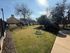 Charming garden view featuring lush greenery, manicured shrubs, and a bright sunny ambiance perfect for relaxation.