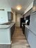 Charming kitchen with sleek gray cabinetry, modern appliances, and elegant wood-style flooring, perfect for culinary enthusiasts.