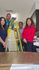 Friendly maintenance team with a yellow ladder in a bright kitchen space, ready for service.
