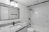 Modern bathroom with elegant granite countertop, sleek fixtures, and luxurious marble shower design.