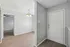 Inviting apartment entrance with sleek light fixtures and modern decor accented by elegant hardwood flooring.