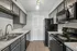 Modern kitchen with sleek gray cabinetry, stainless steel appliances, and elegant countertops creating a sophisticated cooking space.