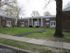 Grover Cleveland Apartments, exterior, two story, red brick building, white columns, grass, walkways, trees