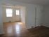 Grover Cleveland Apartments, interior, empty room, wood floors, white walls, front door, slight patrician