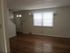 Grover Cleveland Apartments, interior, empty room, wood floors, white walls, front door, slight patrician, large window