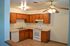 Pine Park Terrace, interior, kitchen, white appliances, dishwasher, stove/oven, tan cabinets, tiled floor, ceiling fan