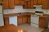 Pine Park Terrace, interior, kitchen, white appliances, dishwasher, stove/oven, tan cabinets, tiled floor, ceiling fan, refrigerator