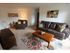 Long Pond Village Apartments, interior, living room, carpeted, natural light, leather sofa and lounge chair, coffee table