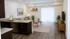 Modern living area with an elegant open kitchen, cozy seating, and natural light.