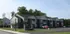 Charming suburban apartment complex with modern design features, surrounded by lush greenery and ample parking.
