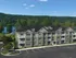 Charming lakeside apartment complex with modern architecture, surrounded by lush greenery and scenic views at Mohawk Riverfront Apartments in Cohoes, NY.