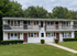 Charming duplex with classic design, featuring inviting balconies and set amidst lush greenery at Halfmoon Garden Apartments in Clifton Park, NY.