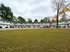 Charming apartment complex with a spacious parking lot and lush green lawn, surrounded by picturesque trees at Canfield Apartments in Gansevoort, NY.